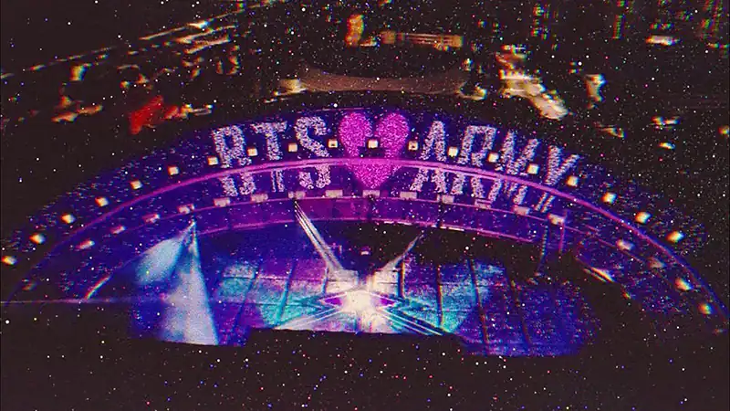 Fans de BTS ARMY con lightsticks en concierto